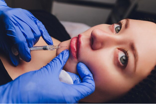 young-woman-receiving-injection-her-lips-close-up_152904-39551.jpg